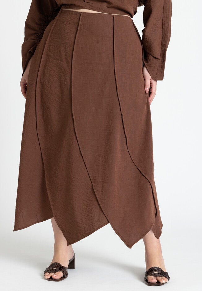 A seam-detail skirt in rich, earthy tones, symbolizing the intersection of craftsmanship and the sacred in 2026 art.